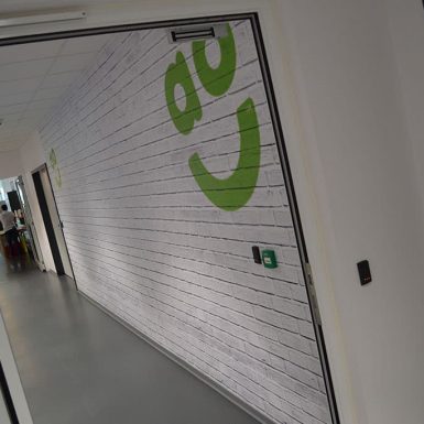 ao.com project digitally printed brick wall effect wallpaper with full colour logo graphics
