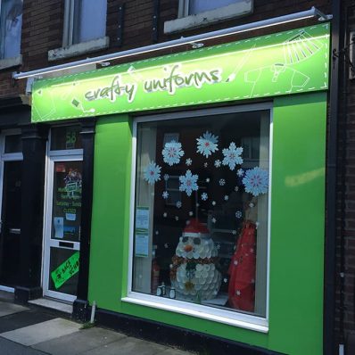 Crafty Uniforms cloths shop - flat panel signs with stand-off lettering and trough lighting.