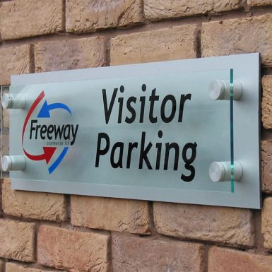 Freeway - clear acrylic plaque wayfinding with cut vinyl on reverse mounted using chrome locations.