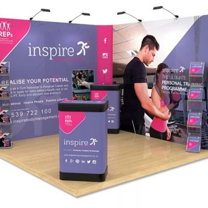 Trade show booth featuring purple and pink Inspire Leisure 3x3 pop-up display stand