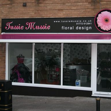 Jussie Mussie Floral shop - with framed sign panel and awning.