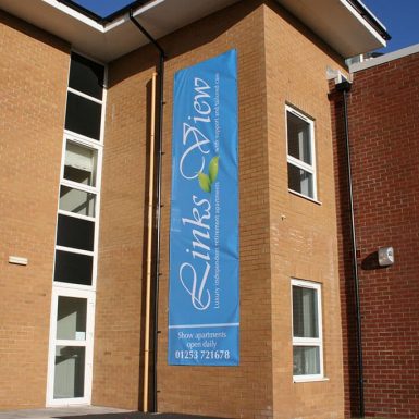 A large building, featuring Links View Lytham St-Annes digitally printed wall mounted PVC banner on the side of it.