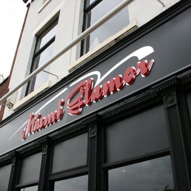 Miami Flames restaurant - framed panels with flat cut acrylic letters and trough lights.