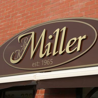 R&K Miller est:1965 - flat sign tray with cut acrylic letters and awning.