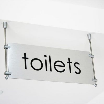 East z East - brushed stainless steel aluminium wayfinding sign with ceiling hanging cable system