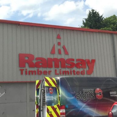 Ramsay Timber - red aluminium comp CNC cut letters mounted on stand-off locators with LED trough light