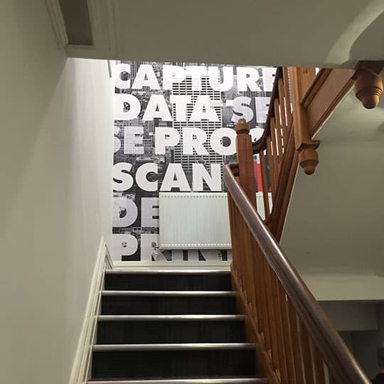Stairwell showcasing wallpaper graphics on wall