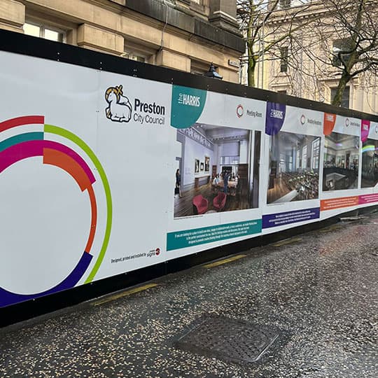 Digital print on large scale hoarding panels banner A digital print billboard on a street, displayed on large scale hoarding panels